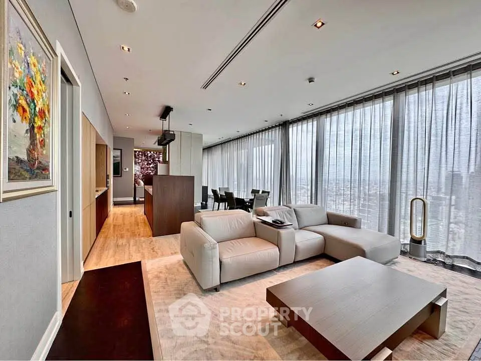 Luxurious modern living room with panoramic city views and elegant furnishings.