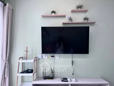 Modern living room with wall-mounted TV and stylish shelves, perfect for contemporary living.