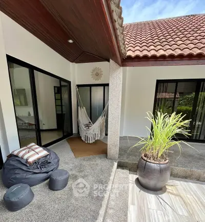 Charming outdoor patio with hammock and modern design, perfect for relaxation.