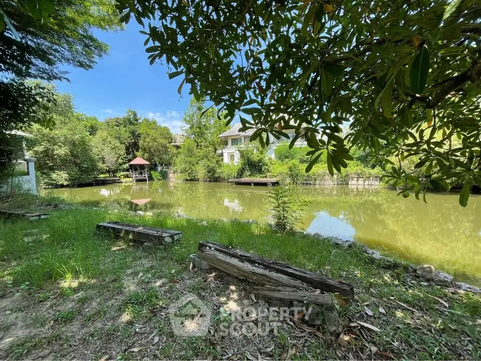 Charming lakeside view with lush greenery and serene surroundings, perfect for tranquil living.