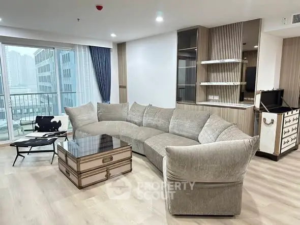 Luxurious living room with modern curved sofa and city view balcony