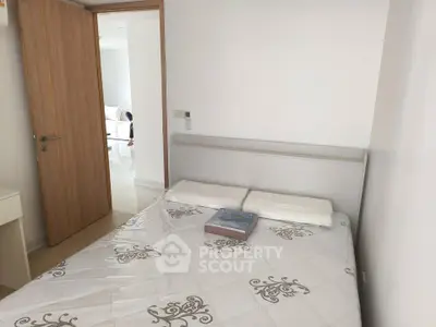 Cozy bedroom with modern decor and natural light, perfect for relaxation and comfort.