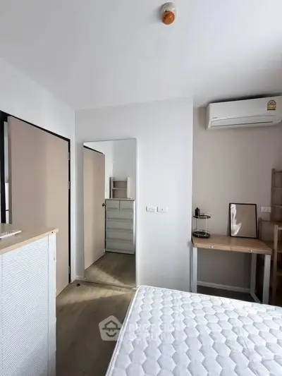 Modern bedroom with minimalist decor and air conditioning unit