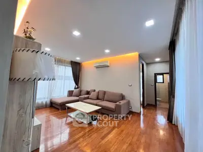 Spacious modern living room with wooden flooring and stylish lighting