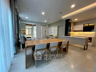 Modern open-layout kitchen and dining area with sleek design and ample natural light.