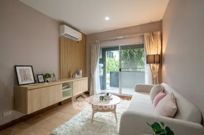 Charming living room with cozy sofa and large window opening to a lush balcony view.