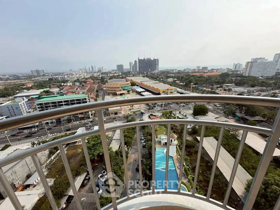 Stunning high-rise balcony view overlooking cityscape and pool, perfect for urban living.