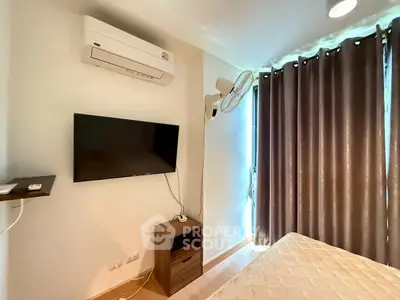 Cozy bedroom with air conditioning and wall-mounted TV, perfect for relaxation.