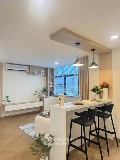 Modern open-layout living room with stylish bar counter and elegant decor