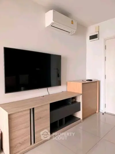 Modern living room with sleek TV unit and air conditioning