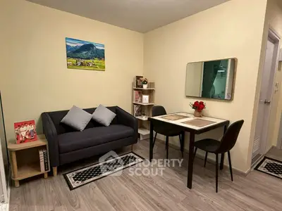 Cozy living room with modern decor and dining area, perfect for small gatherings.