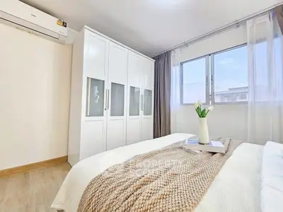 Bright and cozy bedroom with modern decor and ample natural light.