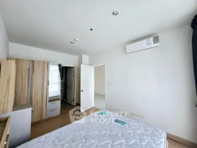 Spacious bedroom with modern air conditioning and ample natural light
