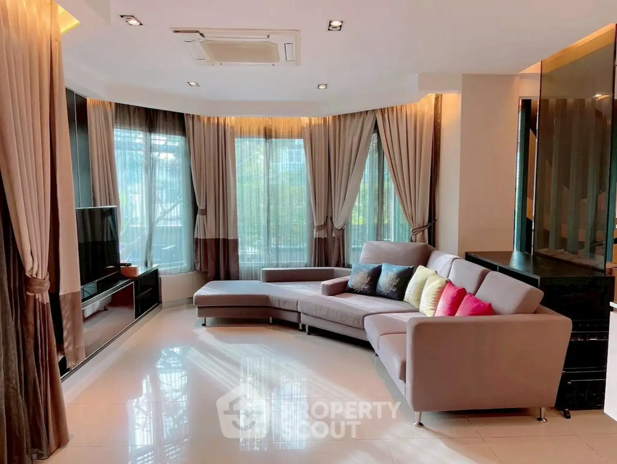 Spacious modern living room with large windows and stylish decor