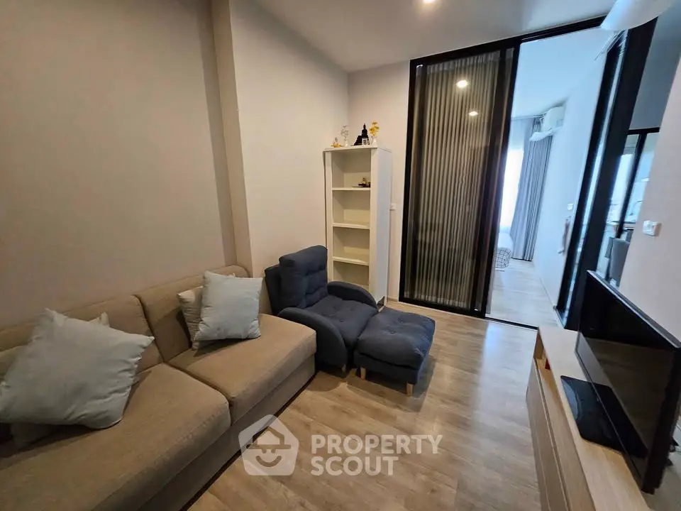Modern living room with cozy seating and stylish decor in a contemporary apartment.