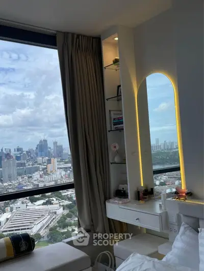 Luxurious bedroom with stunning city view and elegant vanity mirror