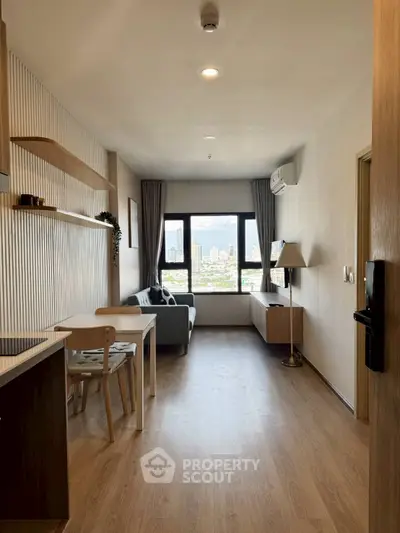 Modern living room with city view, wooden flooring, and stylish furniture in a high-rise apartment.