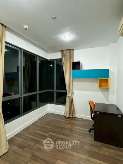 Modern study room with large windows and stylish wooden flooring