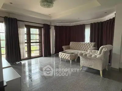 Spacious living room with elegant furniture and large windows for natural light.