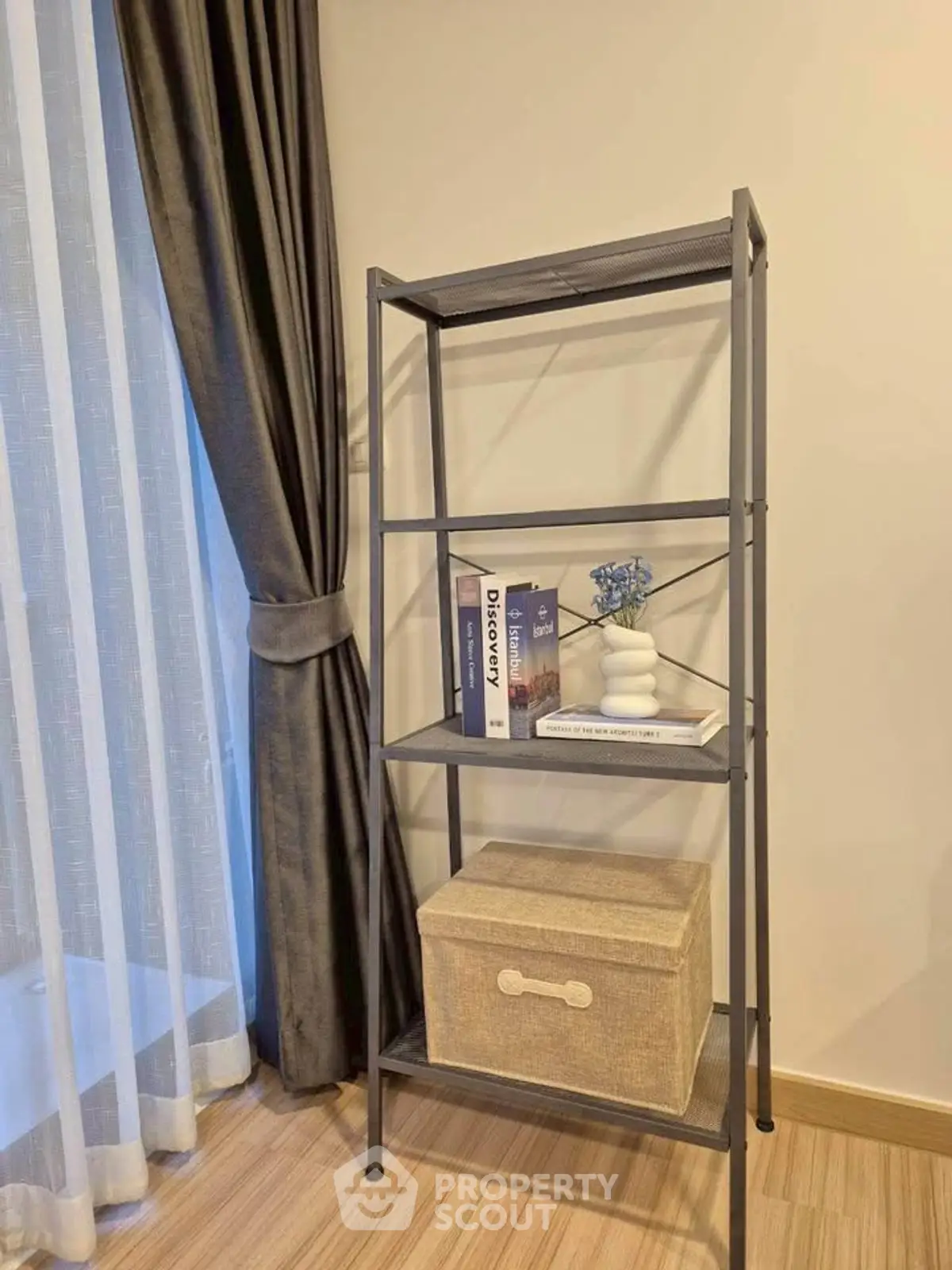 Modern interior with stylish shelving unit and elegant curtains