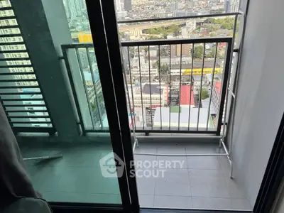 High-rise apartment balcony with stunning city view, perfect for urban living.