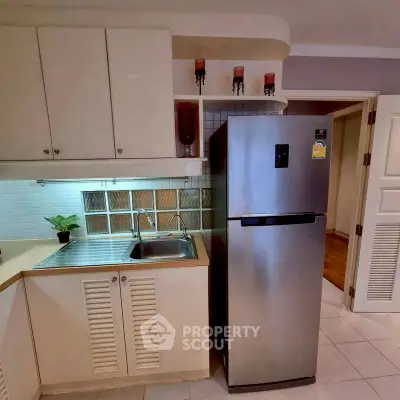 Modern kitchen with stainless steel fridge and sleek cabinetry