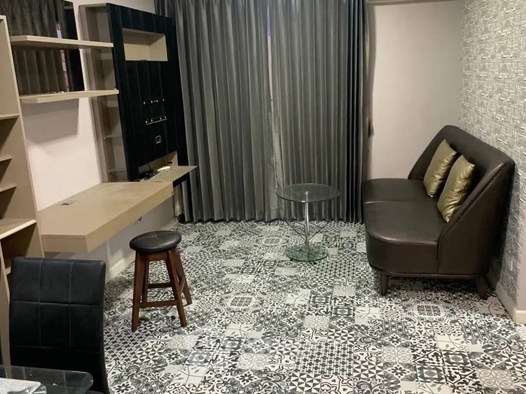 Chic living room with modern decor, patterned floor tiles, and stylish furniture.