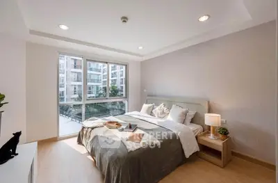 Modern bedroom with large window and stylish decor in urban apartment