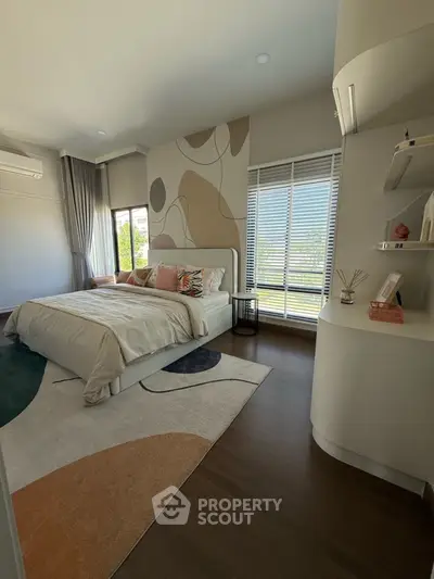 Modern bedroom with stylish decor, large windows, and elegant furnishings in a contemporary home.