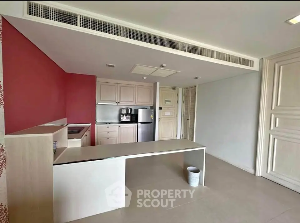 Spacious kitchen with modern appliances and open layout in a stylish apartment.