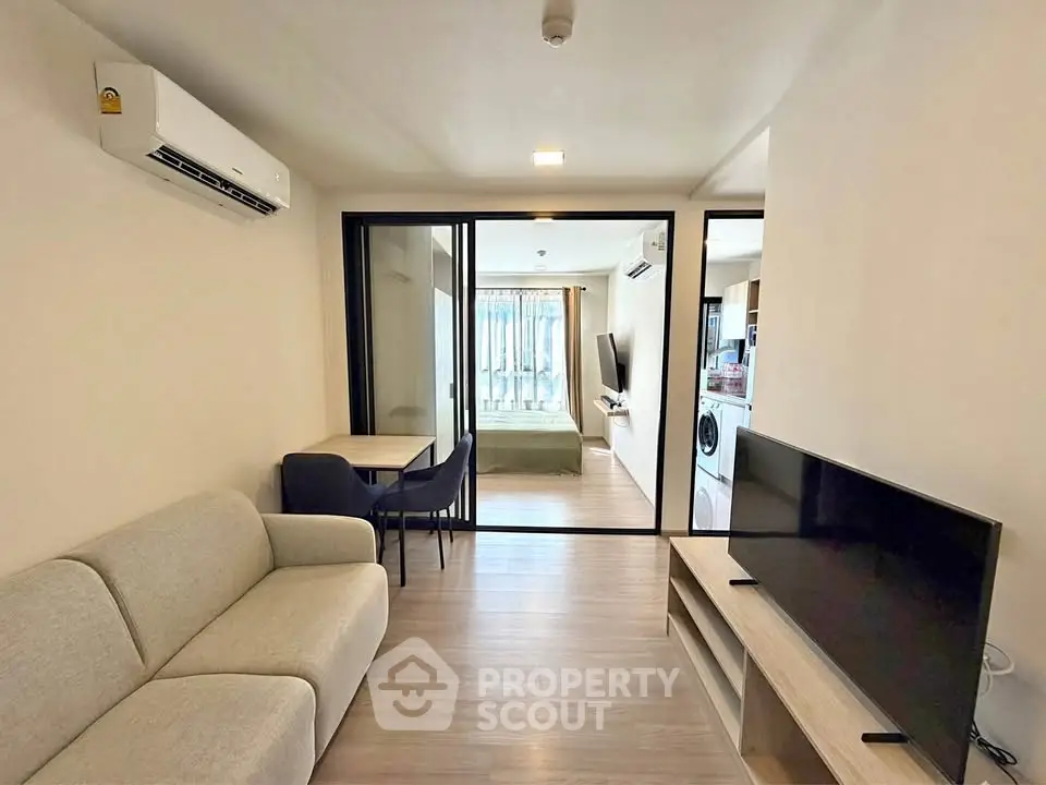 Modern living room with open layout and bedroom view