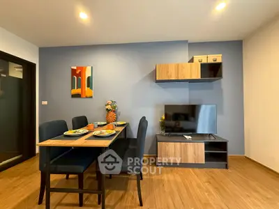 Modern living room with dining area and stylish decor in a cozy apartment.