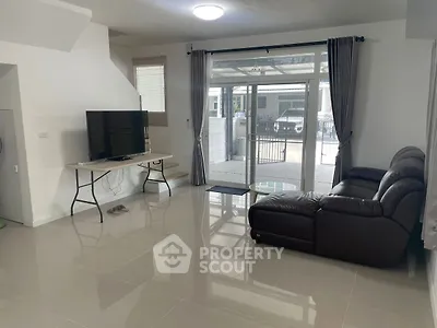 Spacious living room with modern furniture and large windows for natural light.
