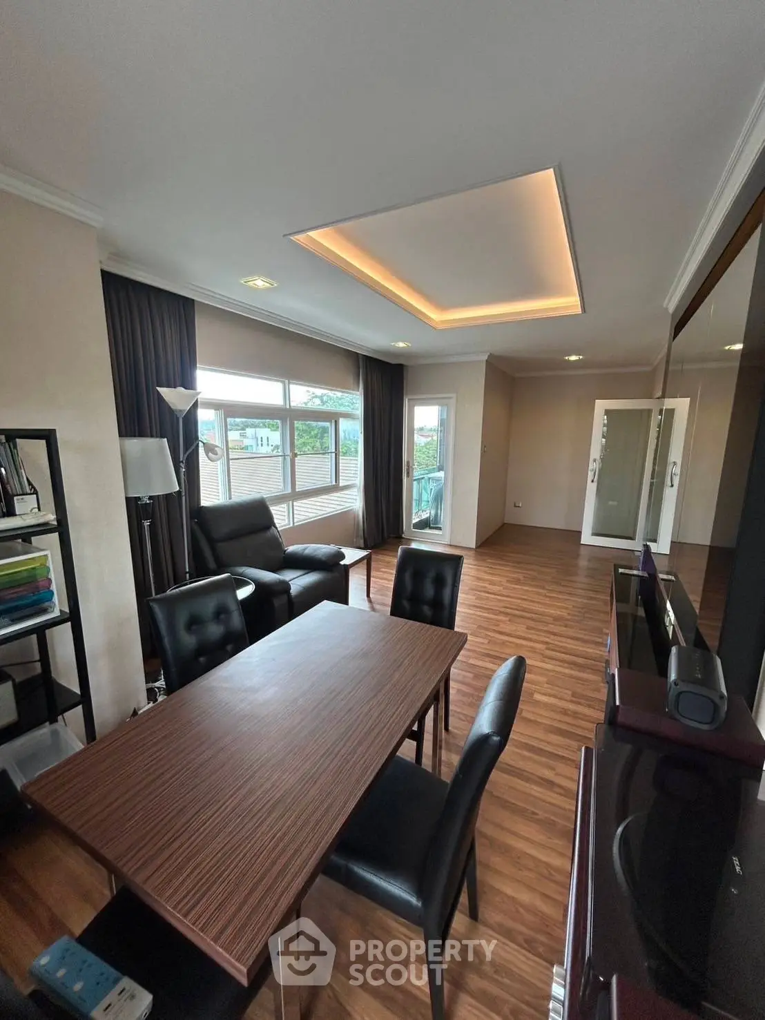 Spacious modern living room with wooden flooring and elegant ceiling lighting