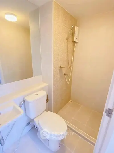 Modern bathroom with shower and toilet in bright neutral tones