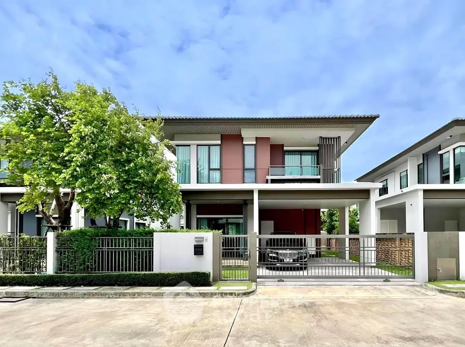 Modern two-story house with spacious driveway and lush greenery