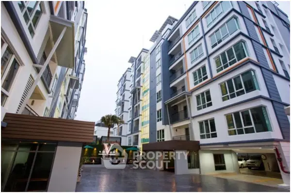 Modern apartment complex with spacious courtyard and contemporary design.