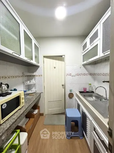 Charming kitchen with closed layout, modern appliances, and ample storage space.