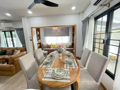 Elegant dining area with modern decor and cozy seating, perfect for family gatherings.