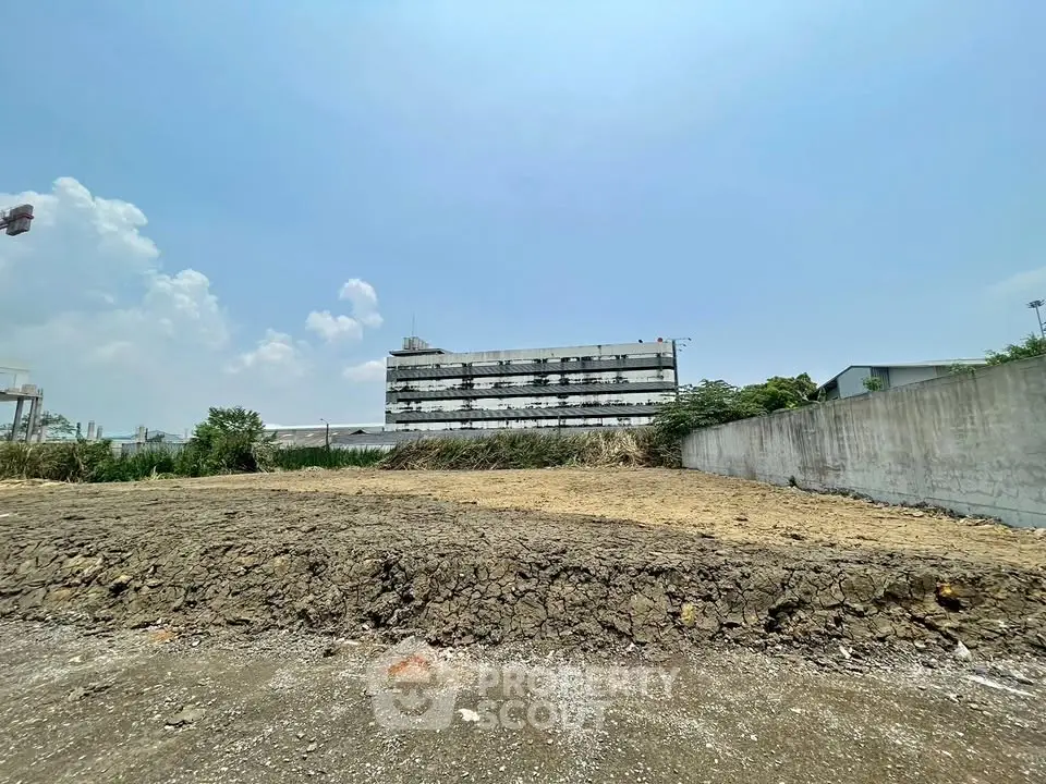 Prime real estate land with potential for development, featuring clear skies and urban surroundings.