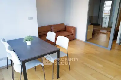 Modern dining area with wooden flooring and cozy seating