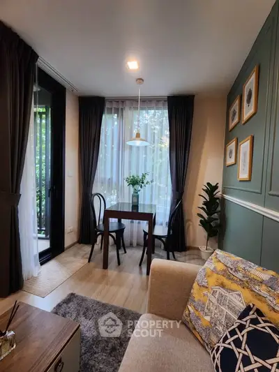 Charming living room with cozy seating and elegant decor, featuring a small dining area by the window.