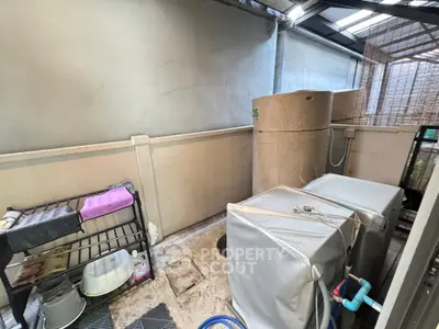 Spacious utility area with water tanks and storage solutions in a modern property.