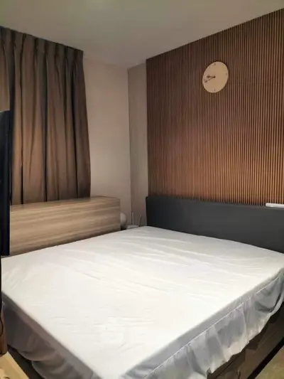 Modern bedroom with stylish wood paneling and cozy ambiance.