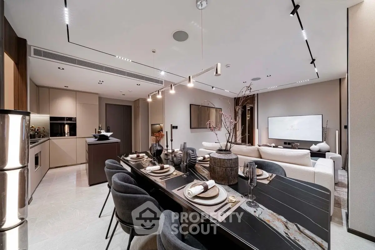 Luxurious open-plan living and dining area with modern decor and elegant lighting.