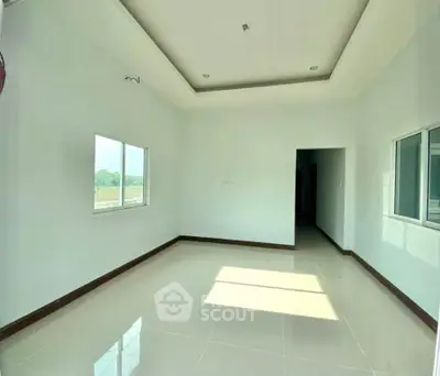 Spacious empty room with large windows and glossy tiled floor, perfect for customization.