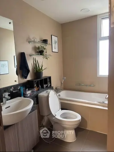 Modern bathroom with bathtub and sleek fixtures in a stylish apartment.