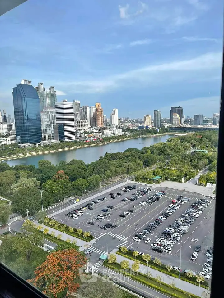 Stunning cityscape view from high-rise building overlooking river and urban skyline.