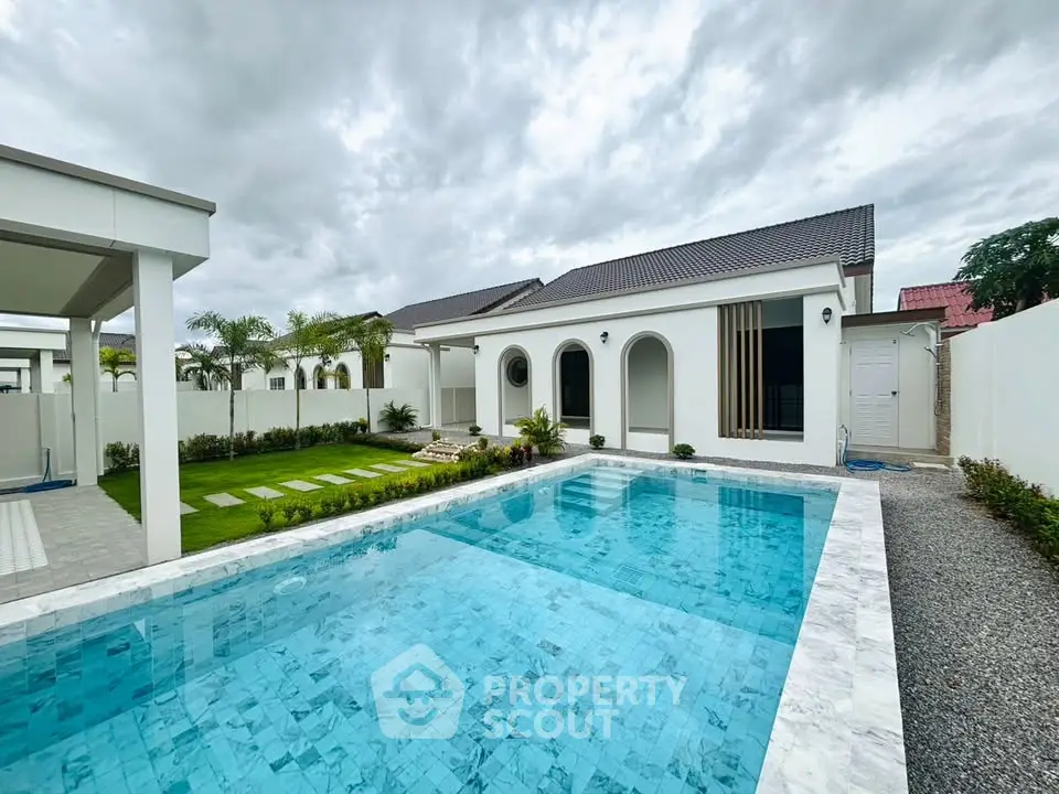 Luxurious modern home with pristine swimming pool and lush garden