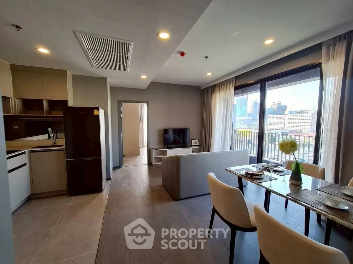 Modern open-plan living room with city view and elegant dining area